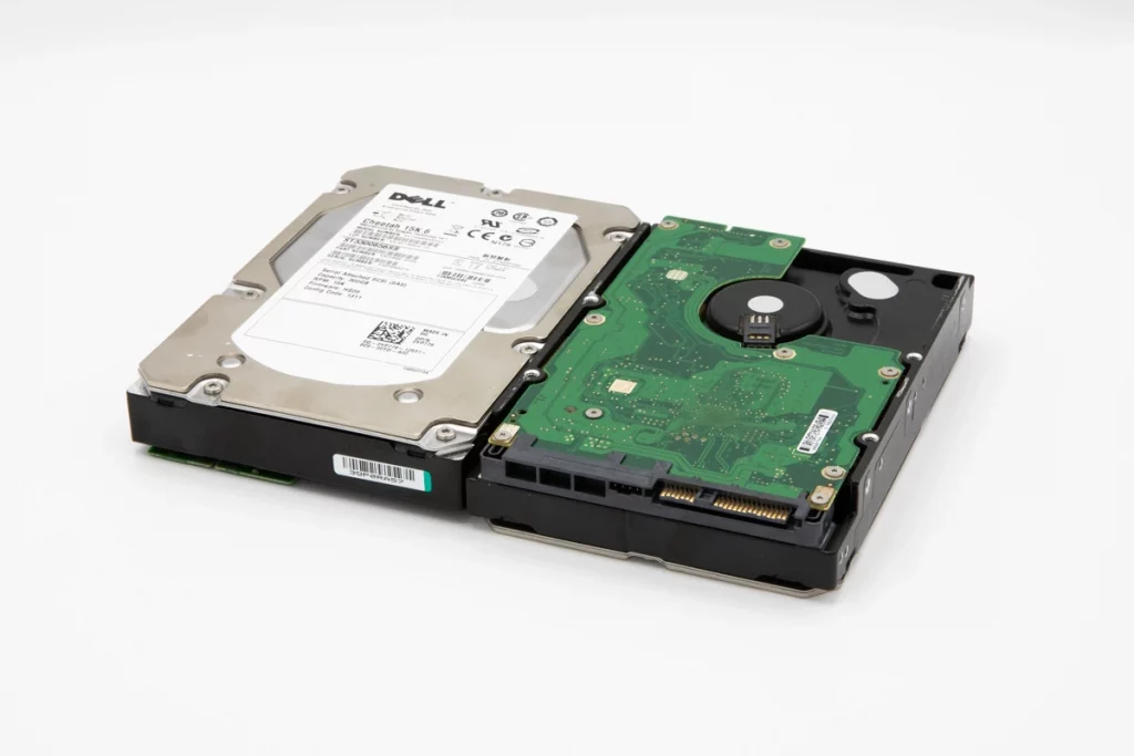 Two Dell hard drives placed side by side, showing front label and green circuit board