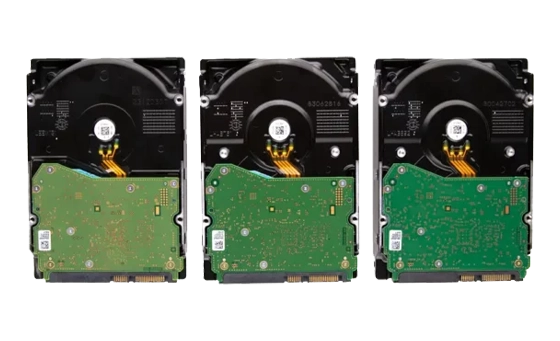 Three internal hard drives with exposed green circuit boards and spindle motors.