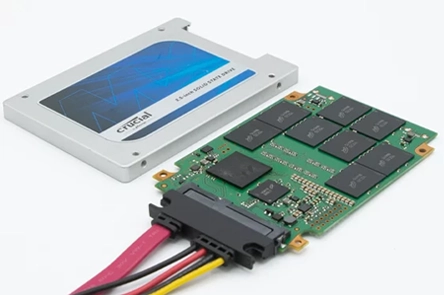 Crucial solid-state drive with removed casing and exposed circuit board.